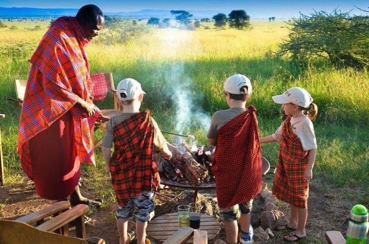Campfire evening with local guide and family travelers